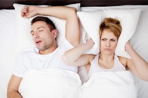Man Snoring, Wife Covering Ears