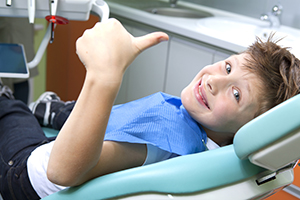 Kid Smiling in a Dental Chair