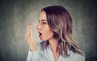 Woman Checking For Bad Breath