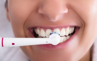 Woman with Electric Toothbrush